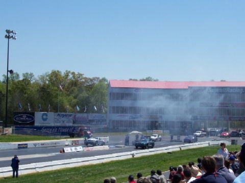 1978 Ford F-250 - Cars are racing on a drag strip with spectators watching from the stands.
