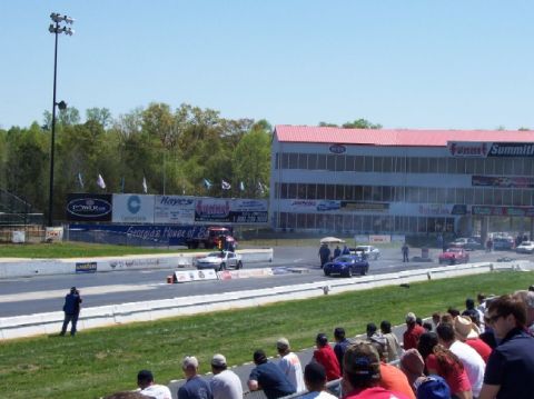 1978 Ford F-250 - A drag racing event is underway with cars on the track and spectators watching from the stands.