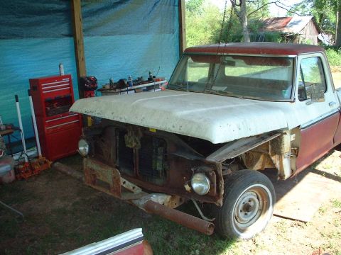 1976 Ford F-150 - Front view of a 1976 Ford F-150 truck undergoing restoration, parked indoors.