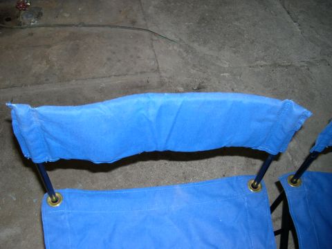 1994 Ford Bronco - Close-up of blue fabric stretched over metal poles, likely parts of a folding chair.