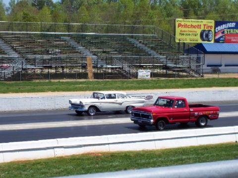 1978 Ford F-250 - A red 1975 Ford F-150 pickup truck races a white 1957 Ford Fairlane sedan at a drag strip.