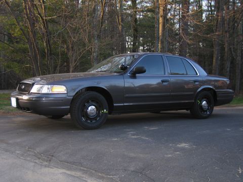 1991 Ford LTD Crown Victoria - This 1991 Ford Crown Victoria LTD is captured in a three-quarter front view, its dark gray exterior.