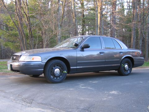 1991 Ford LTD Crown Victoria - Side view of a gray Ford Crown Victoria sedan with tinted windows.