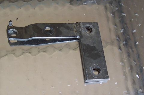 1994 Ford F-150 - A metal bracket, likely a suspension component, is shown against a reflective background.