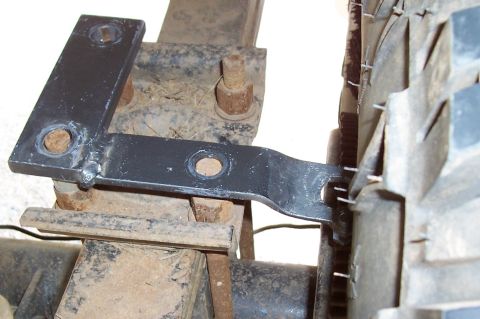 1994 Ford F-150 - Close-up of a black metal bracket mounted on the rear axle assembly, adjacent to a tire.