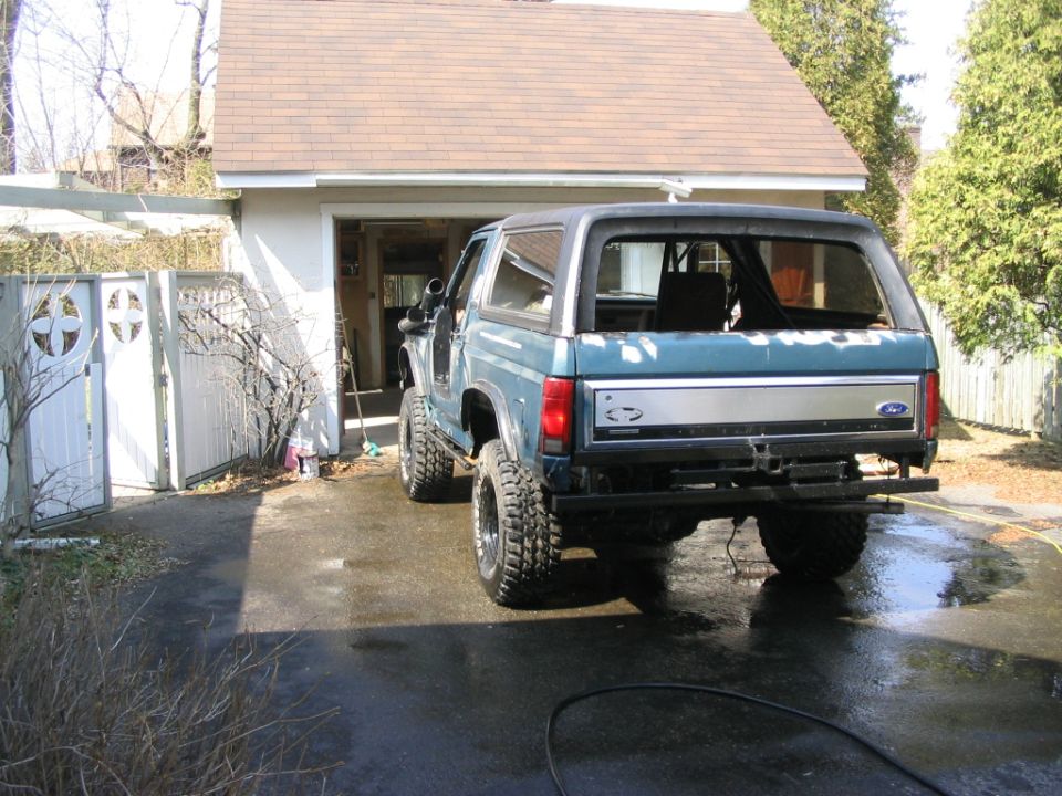 Blue 1986 Ford Bronco rear view with snorkel and aftermarket bumper