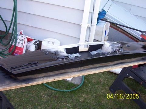 1999 Ford Crown Victoria - A car part, identified as from a Crown Victoria, is seen on a workbench outdoors.