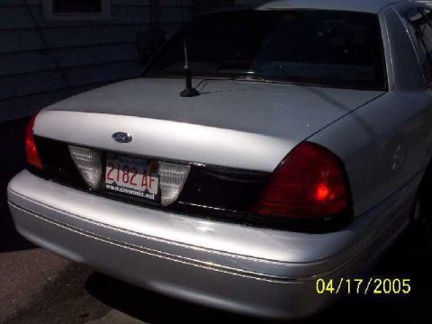 1999 Ford Crown Victoria - Rear view of a 1999 Ford Crown Victoria, showing its distinctive taillights and license plate.