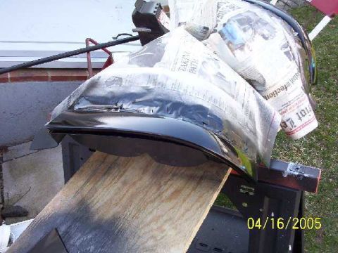 1999 Ford Crown Victoria - Car fender undergoing work, covered with newspaper for protection. Dated 04/16/2005.