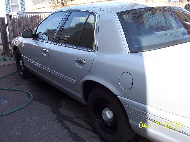 Silver 1999 Ford Crown Victoria side view