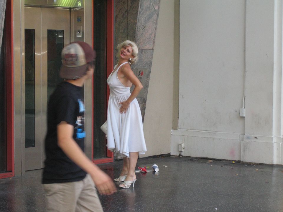 Woman dressed as Marilyn Monroe on sidewalk