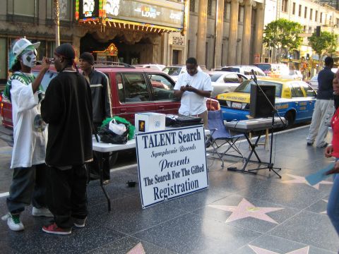 1968 Ford Mustang - Street scene on Hollywood Boulevard with a talent search registration table and various vehicles.