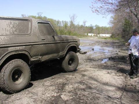 1988 Ford Bronco - Mud-covered 1978 Ford Bronco in a muddy field with a person observing.
