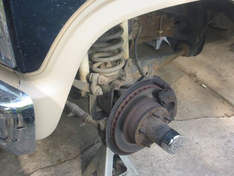 1986 Ford Bronco - Front suspension components, including brake assembly and coil spring, are visible.