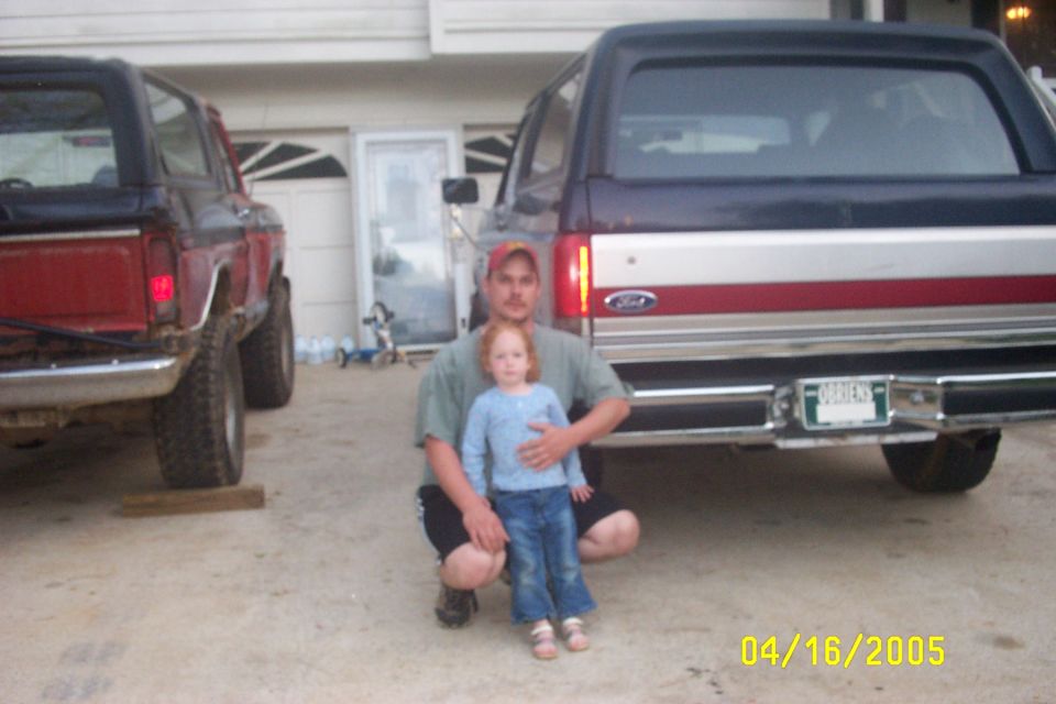 Rear view of a dark blue and red Ford Bronco with a license plate reading "ORRIERS"