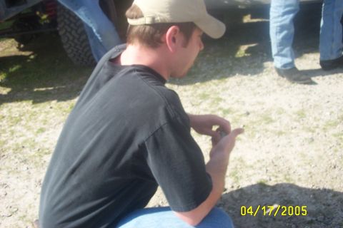 1979 Ford F-150 - A group of people are gathered around a vehicle tire outdoors, with a date stamp of 04/17/2005 visible.