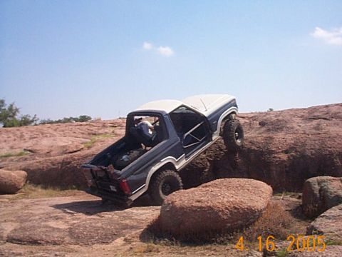 1986 Ford Bronco - This Ford Bronco is navigating a rocky trail with its doors off.