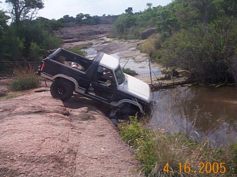 1986 Ford Bronco - This 1986 Ford Bronco tackles a challenging off-road course with one side dipping into the water.