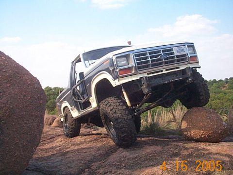 1986 Ford Bronco - This 1986 Ford Bronco navigates a rocky trail, demonstrating its off-road capabilities.
