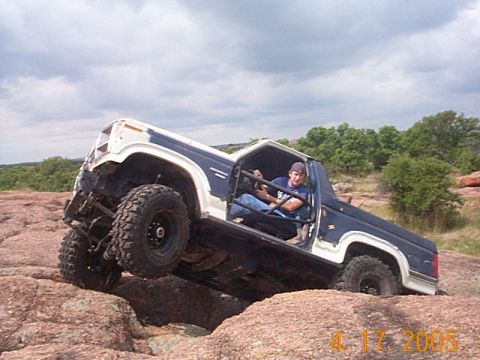 1986 Ford Bronco - This modified 1980s Ford Bronco navigates a challenging rocky terrain.