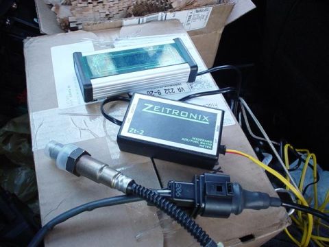 1996 Ford Probe - A Zeitrionix Zt-2 wideband air/fuel ratio meter and O2 sensor are laid out on cardboard.