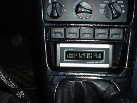 1996 Ford Probe - Interior view of a car's dashboard with climate controls and an aftermarket air-fuel ratio display.
