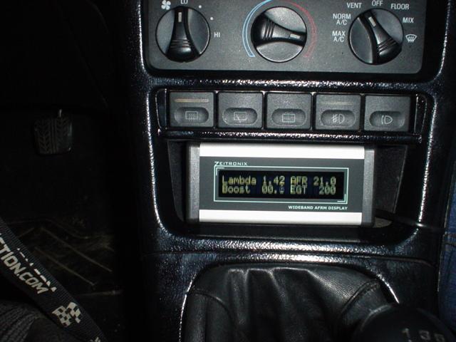 Zeitronix wideband air/fuel gauge in a center console showing lambda, AFR, boost and EGT
