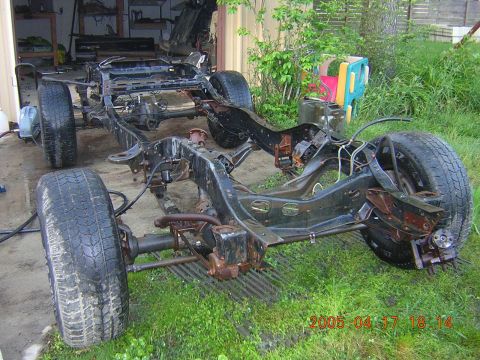 1986 Chevrolet Blazer - The bare frame of a vehicle sits on grass, with a garage in the background and a date stamp of 2005.