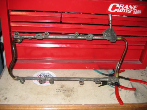 1992 Ford Bronco - A fuel rail assembly is shown with a Crane Cams sticker visible on a red toolbox in the background.