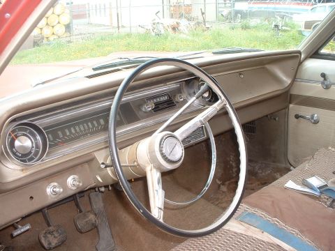 1999 Ford Crown Victoria - The interior of an older vehicle features a classic steering wheel and dashboard instrumentation.