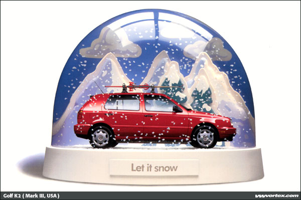 Red hatchback in snow globe with skis on roof