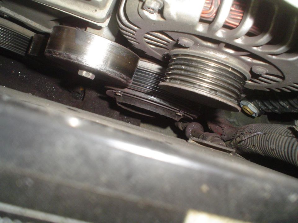 Engine belt tensioner and alternator pulley close-up