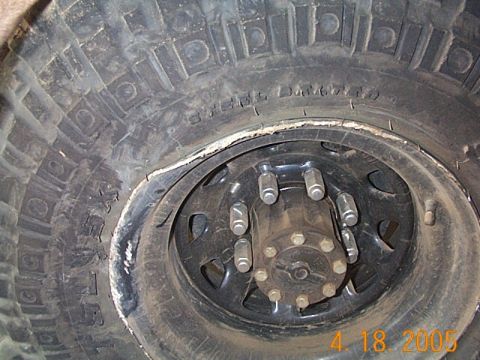 1986 Ford Bronco - This photo shows a damaged tire and wheel, not a 1986 Ford Bronco.