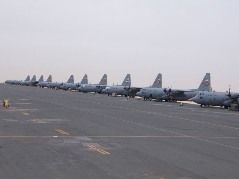 Row of US Air Force cargo planes parked on an airfield