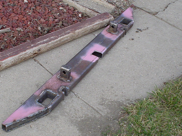 Home-built steel bumper in pink primer with receiver tubes on a driveway