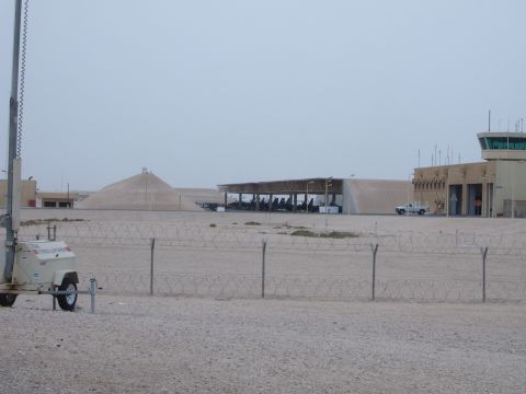 1988 Ford Bronco - A white pickup truck is visible at an airport facility, with a control tower and hangars in the background.