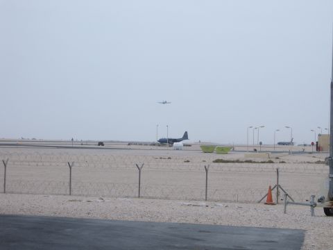 1988 Ford Bronco - Airport scene with multiple aircraft on the ground and in the air, under a hazy sky.