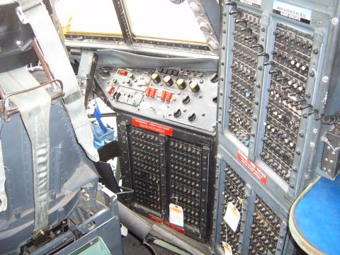 1988 Ford Bronco - Interior view of a cockpit filled with numerous switches, buttons, and dials, suggesting complex electronic systems.