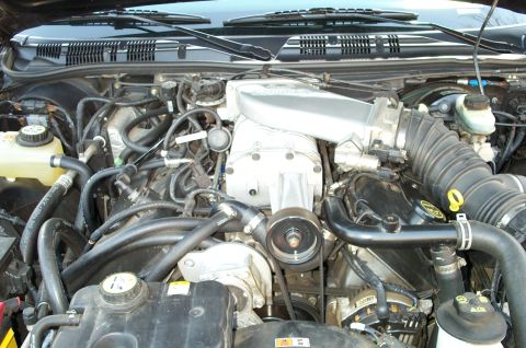 1998 Ford Crown Victoria - Engine bay details are visible, including a supercharger and various hoses.