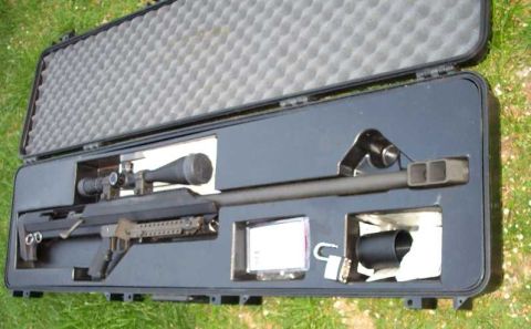 1998 Ford Crown Victoria - A sniper rifle with a scope is stored in a protective case.