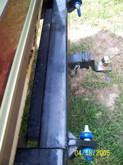1987 Ford Bronco - A close-up view of a vehicle's rear bumper and trailer hitch assembly.