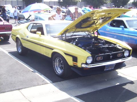 2002 Ford Mustang - Yellow 1971 Ford Mustang Mach 1 at a car show, hood open to display the engine.