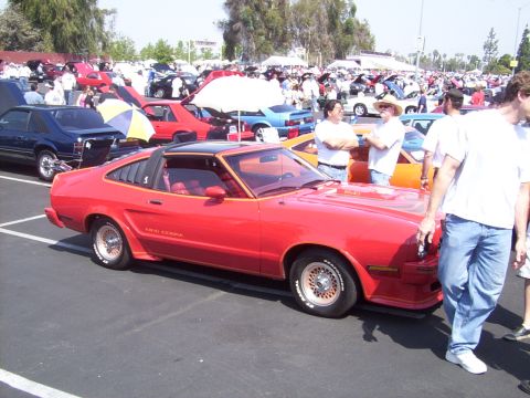 2002 Ford Mustang - Red 1978 Ford Mustang King Cobra coupe with louvers and black t-top parked at an outdoor car show.