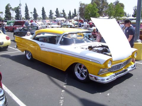 2002 Ford Mustang - Classic 1957 Ford Fairlane 500 on display at a car show, engine visible under the open hood.