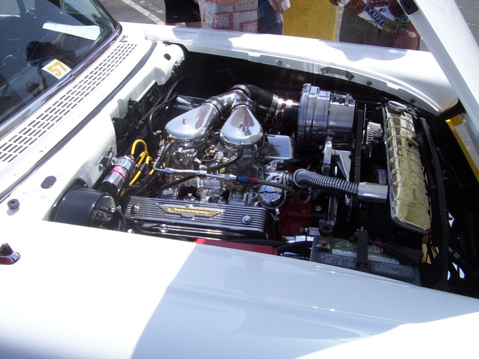 engine bay with dual carburetors, chrome air cleaners, and a 'Thunderbird' valve cover