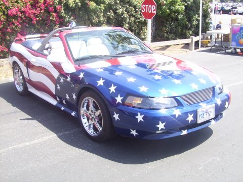2002 Ford Mustang - Custom painted 2002 Ford Mustang convertible displays patriotic American flag artwork and chrome wheels.