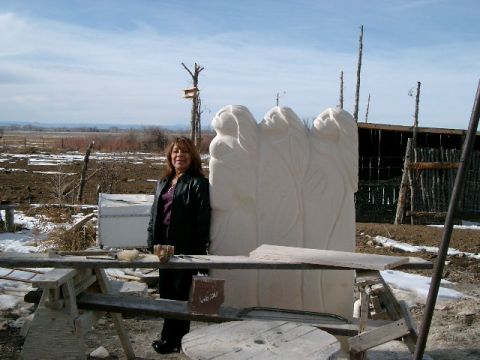 1996 Ford Bronco - A woman poses beside a large, unfinished stone sculpture in a rural, outdoor environment.
