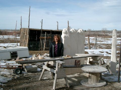1996 Ford Bronco - An artist stands with her stone sculptures in a rural, outdoor workshop with snow on the ground.