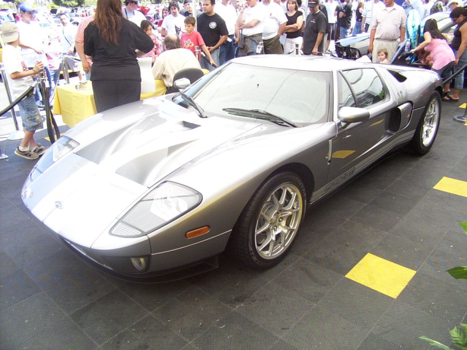 Silver Ford GT with racing stripes on hood and roof