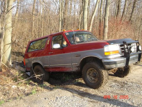 1995 Ford Bronco - 1995 Ford Bronco stuck in mud on a wooded trail.
